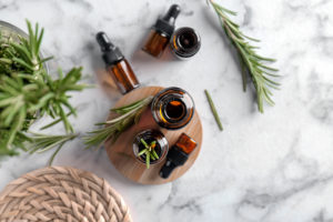 Essential Oil Bottles surrounded by rosemary leaves